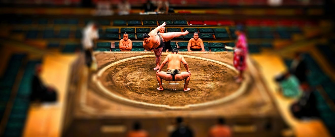 people playing on stadium during daytime