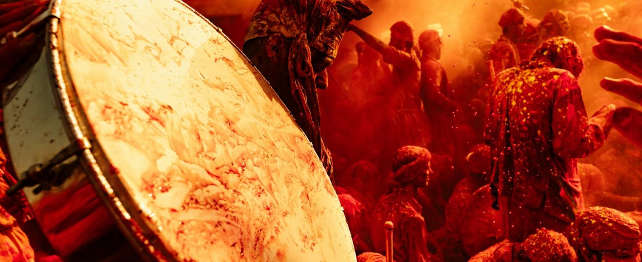 a large group of people covered in red paint